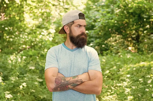 Descendez de vos pieds en chaleur. homme barbu brune porter casquette dans la forêt sur fond d'arbres. brutale brune barbu homme. homme mûr avec barbe en bois. Belle journée d'été. homme barbu regarder avec confiance — Photo