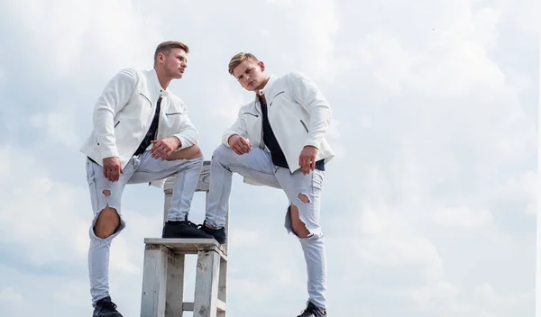 twin brothers men in white casual clothes look alike, male beauty