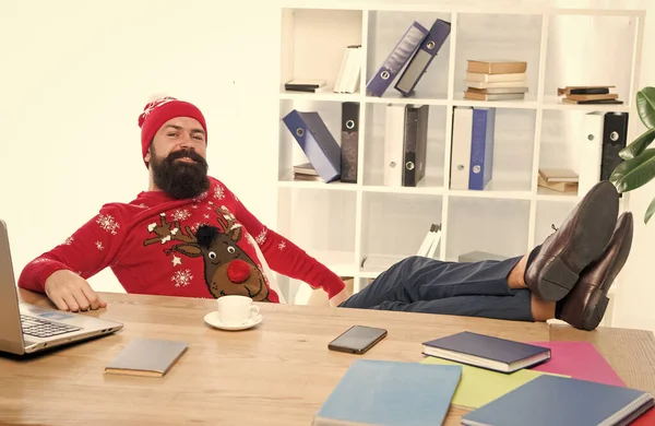 Relax and rest concept. Finally holidays. Man bearded manager in business office. Businessman relaxed successful guy celebrate christmas. Winter holidays. Celebrate xmas. Christmas holidays