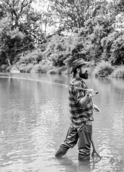 Bearded fisher in water. fisherman with fishing rod. mature man fly fishing. man catching fish. hobby and sport activity. pothunter. summer weekend. Big game fishing. surrender your business — Stock Photo, Image