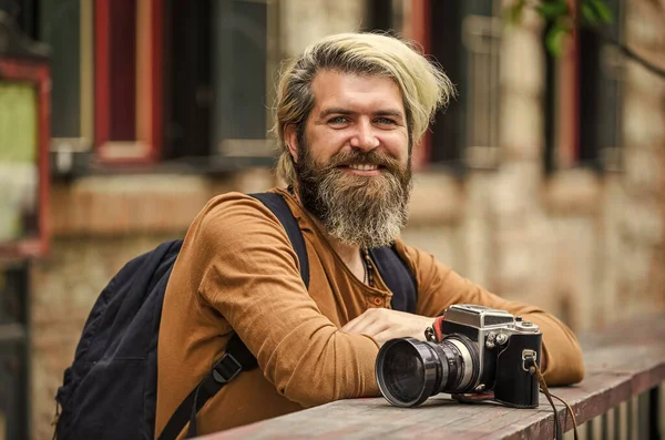 Old technology. Bearded man hipster take photo. Brutal stylish man with retro camera. Modern business. Journalist reporter. Professional photographer use vintage camera. Photography business