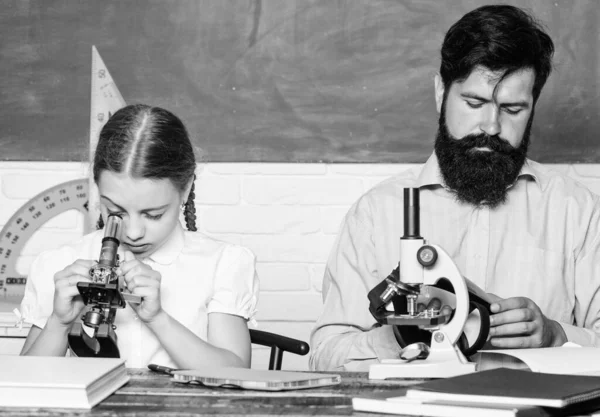 High school. bearded man teacher with small girl in classroom. biology chemistry lesson. father and daughter study in classroom. education and knowledge. back to school. math geometry — Stock Photo, Image