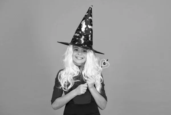 Witching with love. work wonders. carnival costume party. trick or treat. celebrate the holidays. childhood happiness. happy halloween witch girl. child in witch hat. cheerful kid use magic wand — Stock Photo, Image