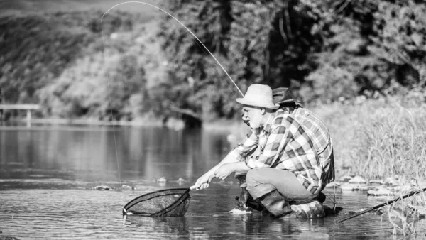Good catch. Bearded men fishing. Family day. Lucky and skilled. Catching fish with friend. Friends catch fish. Fellow fishermen. Spinners and tackle. Nice catch. Bait and hook. Hobby and recreation — Stock Photo, Image