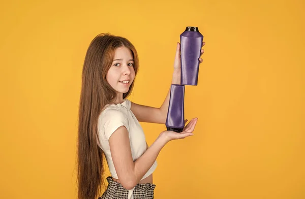 Body care cosmetic bath shower. strong and resilient. cheerful girl ready to condition hair with straightener. teen child cleaning hair with shampoo. kid presenting shower gel. Getting perfect shape — Stock Photo, Image