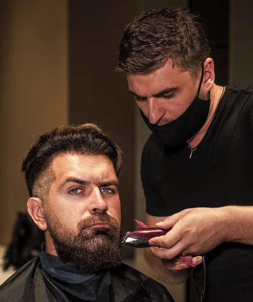 Beard grooming. perfect haircut with blade razor. barber master cut hair. mature hipster with beard at hairdresser. brutal hipster with moustache making new hairstyle. barbershop. male trendy hairdo