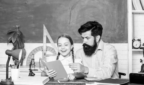 Childrens literature. math geometry. protractor ruler with setsquare. biology chemistry lesson. father and daughter study in classroom. bearded man teacher with small girl use book microscope — Stock Photo, Image