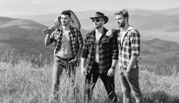 Enjoying happy moments. hiking adventure. cowboy men. men with guitar in checkered shirt. western camping. campfire songs. group of people spend time together. happy men with guitar. friendship