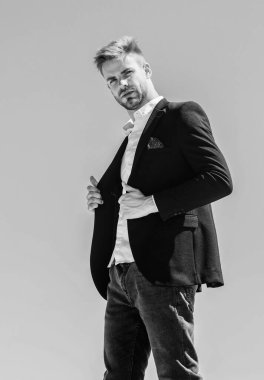 Çalışmaya hazırım. Erkek modası. Resmi tarz. Kendine güvenen yakışıklı iş adamı. Yakışıklı bir manken. Mavi gökyüzü arka planında resmi takım elbiseli yakışıklı bir adam. Ofis çalışanı. Kusursuz görünüyor.