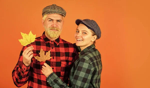 Happy Thanksgiving day. retro couple autumn leaves. man and woman hold maple leaf. farmer in countryside collect fallen leaves. fall seasonal concept. Autumn harvest with Farmers. copy space