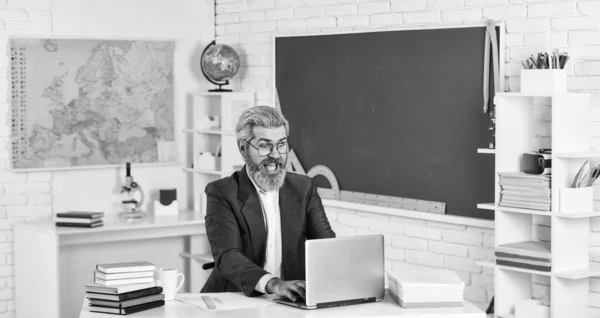 Knowledge day. Man work school teacher sit in classroom. Handsome hipster mature smart educator. Use laptop and internet. Officially submitted application online. School homework. Back to school — Stock Photo, Image