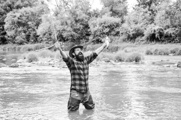 Hobby for reel men. fisherman show fishing technique use rod. mature man fly fishing. man catching fish. bearded fisher in water. summer weekend. Happy fly fishing. hobby and sport activity — Stock Photo, Image