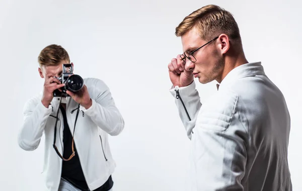 twin brothers men photographer in white casual look alike use vintage photo camera, photographing.