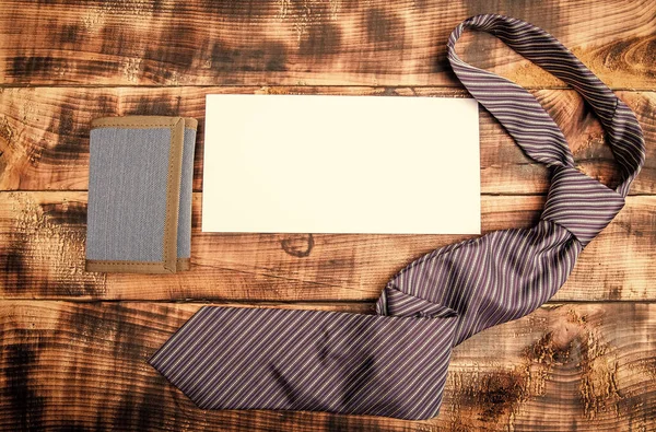 Gebonden formele stropdas en heren portemonnee met stuk papier voor kopieerruimte houten achtergrond, accessoire — Stockfoto