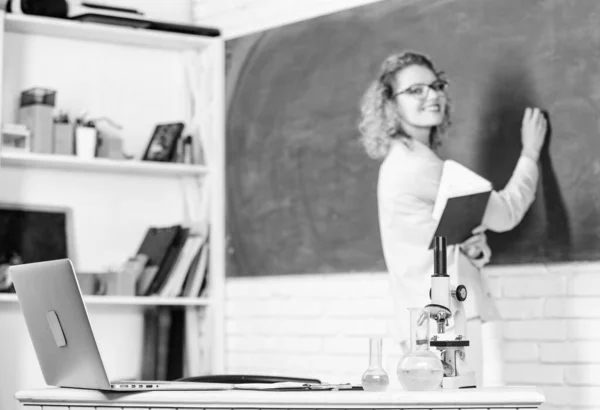 Biology laboratory. Microbiology and bioengineering. Microscope ant tubes with chemical liquids on table school biology teacher selective focus. Biology concept. Student writing chalkboard defocused — Stock Photo, Image