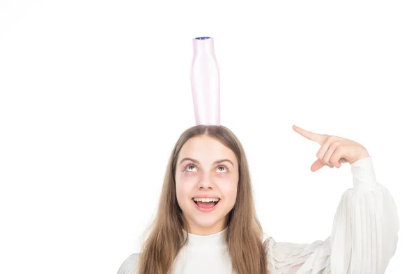 Glückliches Kind zeigt mit dem Finger auf Shampoo oder Haarspülung Flasche isoliert auf weiß, Conditioner — Stockfoto