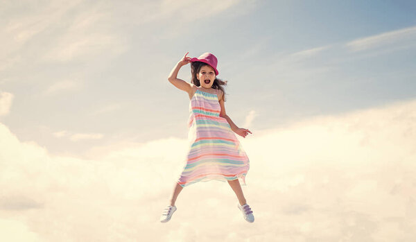 Spring season weather. summer fashionable look. freedom. beautiful teen girl jump in hat. kid fashion style. female natural beauty. happy childhood. cute child on sky background.
