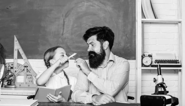 Private lesson. School teacher and schoolgirl. Pedagogue skills. Talented pedagogue. Work together to accomplish more. Man bearded pedagogue. Homeschooling with father. Find buddy to help you study