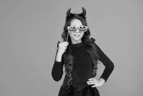 Real witch in disguise. child with funny party attribute. teen girl has curly hair wear dress for holiday celebration. autumn season holidays. childhood leisure. happy halloween. kid wear devil horns — Stock Photo, Image