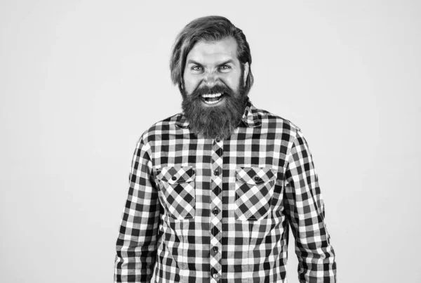 Angry handsome bearded guy with unshaven face and stylish hairdo wear casual clothes, anger — Stock Photo, Image