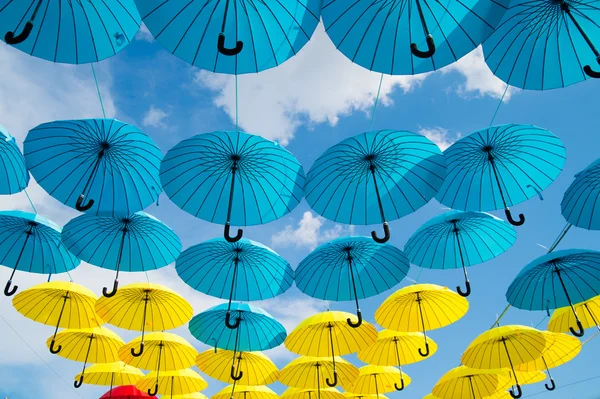 Bright colorful yellow and blue umbrellas background — Stock Photo, Image