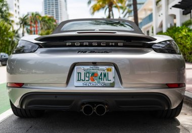 Miami, Florida, USA - July 27, 2025: Porsche 718 Boxster 2022 sport car convertible. Luxury convertible car Porsche 718 Boxster. Car Porsche 718 Boxster parked outdoor. Silver car, rare view.
