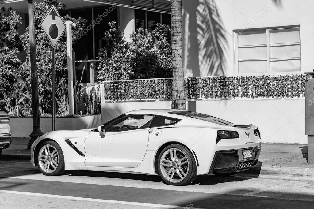 Miami Beach, Florida USA - June 9, 2024: Porsche Taycan white color at miami beach. luxury car porshche at ocean drive Miami beach. front corner view