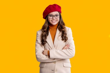 Back to school. Teen girl in autumn fashion style. School time. Teen girl isolated on yellow. Girl wearing autumn coat. Autumnal fashion and teen style. Fall season style. September 1.