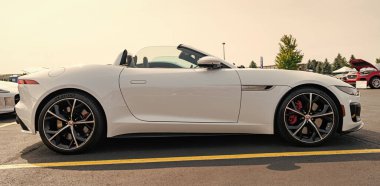 Chicago, Illinois, USA - September 08, 2024: Jaguar F-TYPE R75 AWD Convertible vehicle, side view. Modern Jaguar F-TYPE R75 AWD Convertible car white color. F-TYPE R75 AWD Convertible car. F-TYPE R75 AWD Convertible at Chicago