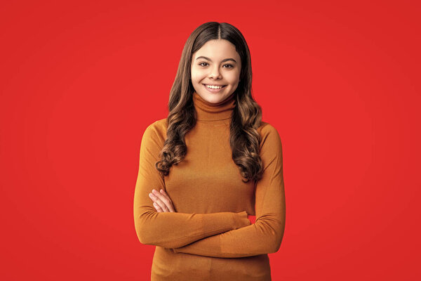 Trendy stylish teen. Fashion style for teen. Portrait of girl has curly hair. Stylish girl in casual sweater. Teen girl wear casual style isolated on red. Teen fashion girl. Neutral color palette.