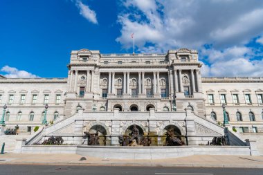 Congress in Washington DC. Congress building under blue sky. Washington DC landmark. American flag above the Congress. Congress historic symbol of American democracy.