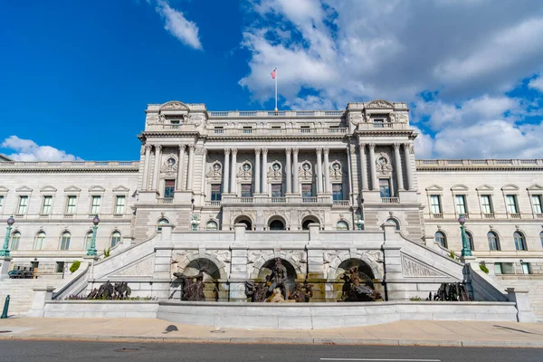 Congress in Washington DC. Congress building under blue sky. Washington DC landmark. American flag above the Congress. Congress historic symbol of American democracy.
