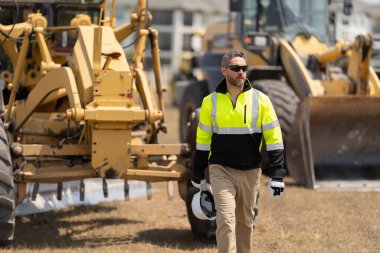 Top supervisor at work. Labor day. Building side. Man at construction site. Civil construction engineering. Man engineer at building site. Supervisor worker wear uniform. Architecture consultant.