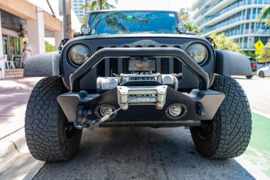 Miami, Florida, USA - April 13, 2025: SUV car Jeep Wrangler. Car Jeep Wrangler parked outdoor. Black Jeep Wrangler car, front view. Jeep Wrangler SUV car.