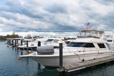 Vacation on summer. Yacht charter. Sea vacation on summer. Luxury boat motor yacht in marina. Luxury yacht docked in marina sea. Boating and yachting tourism. Luxurious lifestyle.