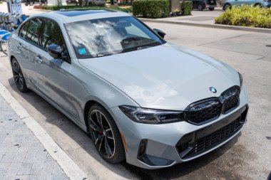 Miami, Florida, ABD - 19 Nisan 2025: BMW M340i 2023 spor araba sedanı. Lüks sedan spor araba M3 yarışması. Araba M3 yarışması XDrive dışarıda park halinde. Limon rengi sedan araba, yan görüş.