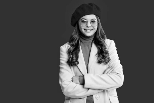 Autumn fashion girl. Trendy and stylish teenager girl, copy space. Fall fashion style for teen. Complete outfit for fall style. Girl in autumn coat isolated on red. Teen girl wear sunglasses.