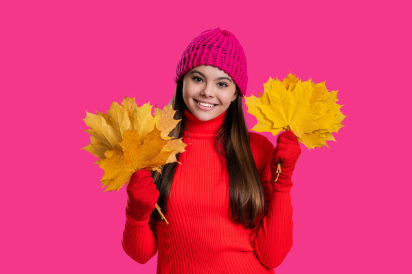 Autumn and leisure. Fall leaves and beautiful girl. Stylish girl hold maple leaves. Fall season. Hello autumn. Carefree teen girl in hat and gloves isolated on pink. Autumn foliage. Yellow leaves.