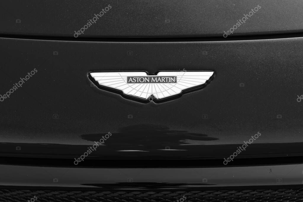 Chicago, Illinois, USA - September 08, 2024: Aton Martin on red background. Logo of the british luxury sports car manufacturer Aston Martin founded in 1913..