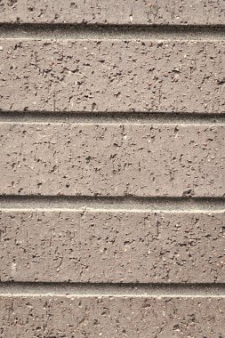 Tuğla duvarın yüzeyi. Kalıplaşmış kahverengi fon. Duvar dokusu arka planı. Tuğla duvar yapısı. Tuğla ustalığı geçmişi. Malzeme konsepti. Açığa çıkmış tuğla dokusu.