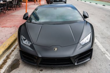 Miami, Florida, ABD - 13 Temmuz 2025: Lamborghini Huracan 'ın arabası açık havada park edildi. Lamborghini, ön manzara. Lamborghini Huracan 2019 spor araba süper arabası. Lüks siyah mat araba Lamborghini Huracan.