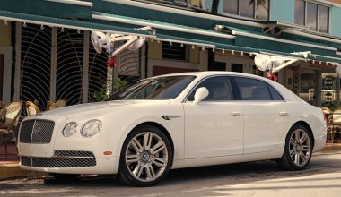 Miami, Florida, ABD - 17 Aralık 2024: 2016 Bentley Flying Spur Vur Sedan Car. Lüks araba beyaz Bentley Flying Spur V8 tipi. Bentley Uçan Mahmuz 'un arabası dışarıda park edilmiş. Bentley Uçan Mahmuz, yan görünüm.