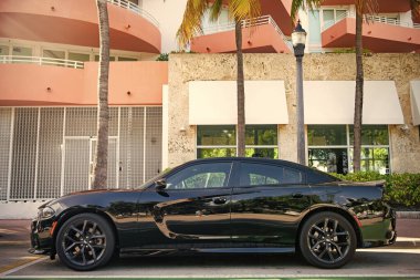 Miami, Florida, ABD - 17 Aralık 2024: Siyah 2023 Dodge Charger GT arabası. Dodge Charger GT tipi lüks bir araba. Dodge Charger GT 'nin arabası, dışarıda park edilmiş. Dodge Charger GT, yan görünüm.