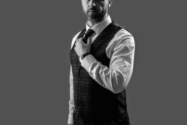 Zarif terzilik yeleği giymiş bir iş adamı. Gri kravatlı resmi takım elbise. Erkek giyim kuşamı. Bespoke takımı. Resmi erkek giyim konsepti. Formalite icabı iş adamı. Kesik manzaralı. Resmi Kumaşlar.