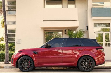 Miami, Florida, ABD - 17 Aralık 2024: 2019 Land Rover Range spor arabası. Land Rover 'ın lüks spor arabası. Range Rover 'ın kırmızı renkli arabası dışarıda park edilmiş, yan görünüm