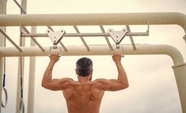 Spor barfiks egzersizi. Spor eğitimi. Sporcu adam egzersiz yapıyor. Adam kaslı sırt sporcusu açık hava spor salonuna geldi. Spor yaşam tarzı. Kas kasları ve trisepsler. Güçlü bir atlet. Adam yanaşıyor..