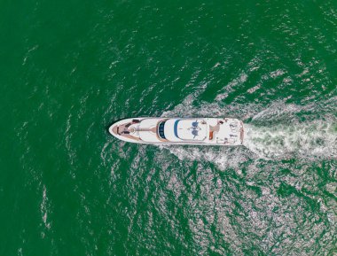 Yaz denizi kıyısında bir tekne turu. Denizdeki lüks yat teknesi. Yaz tatili. Lüks yat manzaralı. Motorlu teknenin panorama hava görüntüsü. Marinaya yüzen bir tekne. Açık deniz.