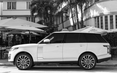 Miami, Florida, ABD - 17 Aralık 2024: Land Rover Range 2018 geçiş aracı. Land Rover 'ın lüks aracı. Beyaz araba Range Rover 'ı dışarıda park etmiş, köşe manzaralı.