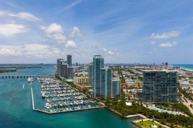 Luxury yacht docked at Miami marina. Aerial view of coastline in Miami. Sailboat cruising along the Miami shore