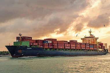Miami, Florida, ABD - 16 Aralık 2024: konteyner gemisi. Yük Chloe D Monrovia gemisi, konteynır, insansız hava aracı görüşlü. Kargo gemisinde nakliye konteynırı. Kargo gemisi. Gün batımında Miami Limanı.